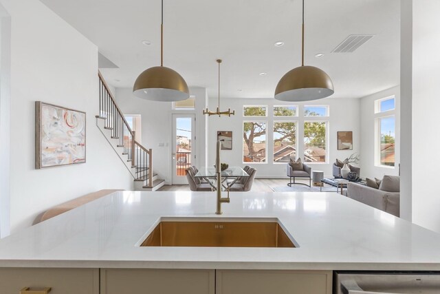 3824 Wilmer St, Houston, TX 77003 - kitchen with decorative light fixtures, light countertops, a sink, visible vents, and open floor plan