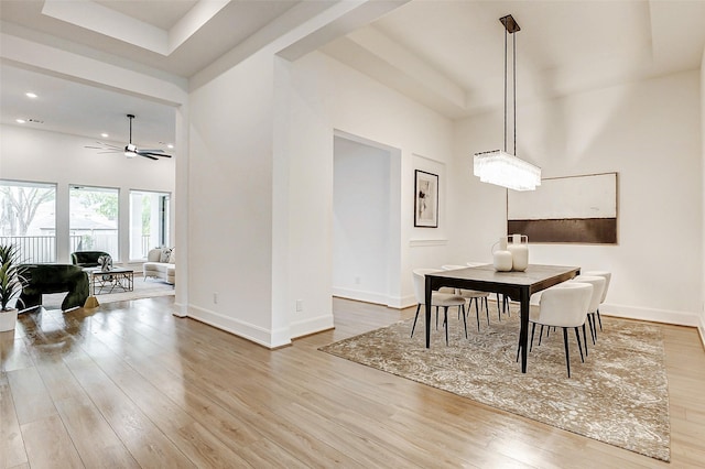 dining space with wood finished floors, baseboards, and ceiling fan