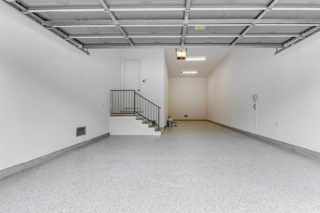 garage featuring visible vents and a garage door opener