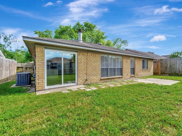 403 Elder Vista Dr, Houston, TX 77598 - back of house with brick siding, a patio area, a lawn, and a fenced backyard