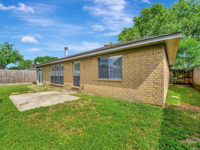 403 Elder Vista Dr, Houston, TX 77598 - rear view of property with a patio area, a fenced backyard, brick siding, and a yard