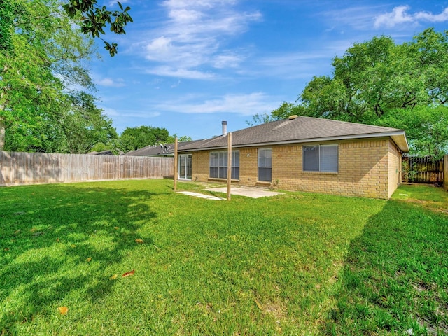 403 Elder Vista Dr, Houston, TX 77598 - rear view of property with a lawn, brick siding, a patio area, and a fenced backyard