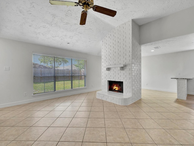 403 Elder Vista Dr, Houston, TX 77598 - unfurnished living room with ceiling fan, a brick fireplace, a textured ceiling, and light tile patterned floors
