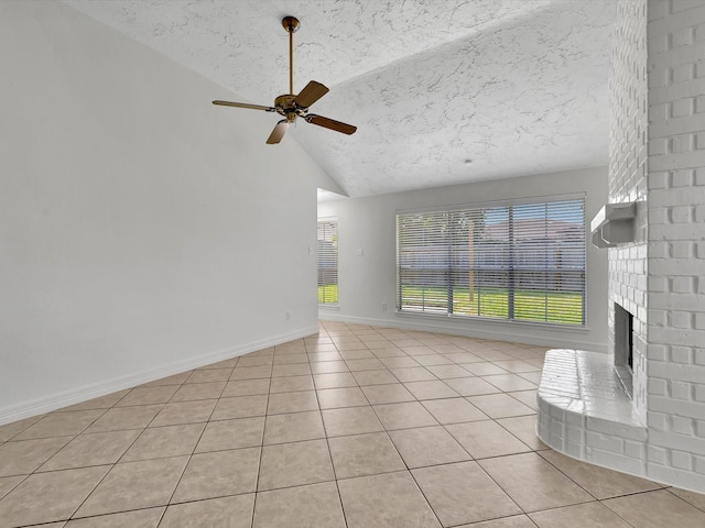 403 Elder Vista Dr, Houston, TX 77598 - unfurnished living room featuring a ceiling fan, light tile patterned flooring, a textured ceiling, and a fireplace