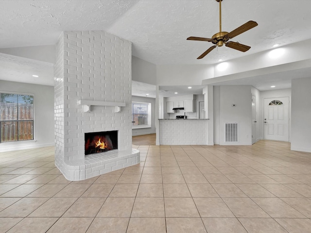 403 Elder Vista Dr, Houston, TX 77598 - unfurnished living room with visible vents, lofted ceiling, ceiling fan, a fireplace, and light tile patterned floors