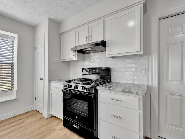 403 Elder Vista Dr, Houston, TX 77598 - kitchen featuring black gas stove, decorative backsplash, under cabinet range hood, and light wood finished floors