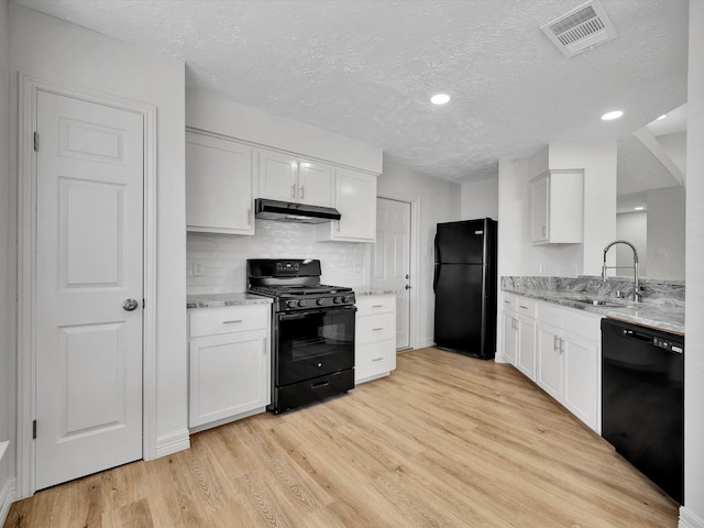 403 Elder Vista Dr, Houston, TX 77598 - kitchen featuring a sink, a textured ceiling, visible vents, under cabinet range hood, and black appliances