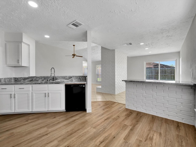 403 Elder Vista Dr, Houston, TX 77598 - kitchen with dishwasher, ceiling fan, light wood finished floors, and visible vents