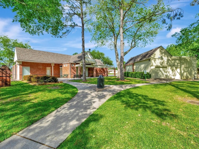 403 Elder Vista Dr, Houston, TX 77598 - ranch-style house featuring a front lawn, brick siding, an outdoor structure, and a garage