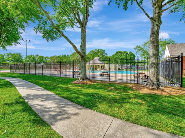 403 Elder Vista Dr, Houston, TX 77598 - view of community featuring a lawn, fence, and a pool