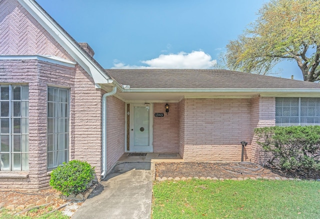 1345 10th St, Hempstead, TX 77445 - doorway to property with a chimney, brick siding, and a shingled roof