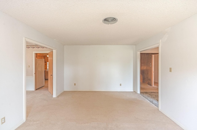 1345 10th St, Hempstead, TX 77445 - unfurnished room with a textured ceiling, light colored carpet, and visible vents