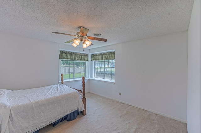 1345 10th St, Hempstead, TX 77445 - carpeted bedroom featuring ceiling fan, baseboards, a textured ceiling, and visible vents