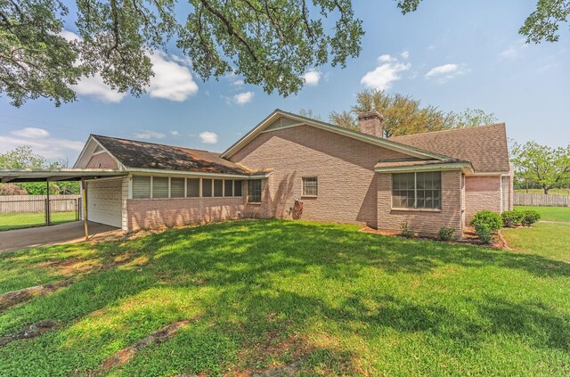 1345 10th St, Hempstead, TX 77445 - exterior space with brick siding, a yard, a chimney, and fence