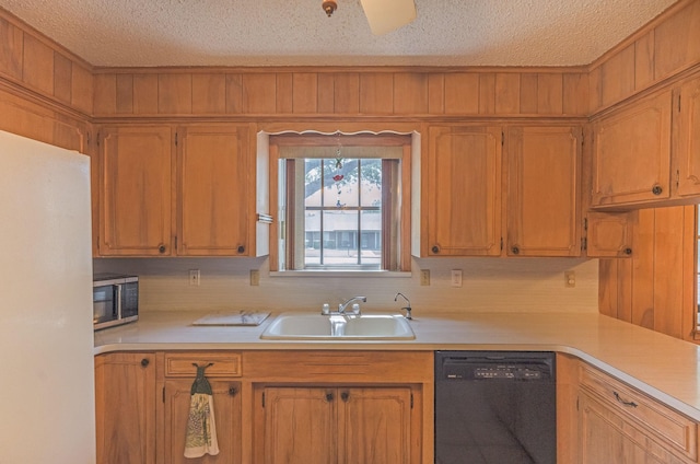 1345 10th St, Hempstead, TX 77445 - kitchen featuring stainless steel microwave, a sink, black dishwasher, and light countertops