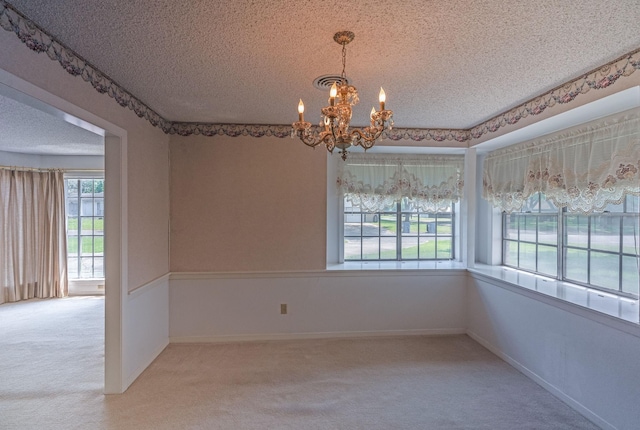 1345 10th St, Hempstead, TX 77445 - unfurnished dining area featuring visible vents, carpet floors, a textured ceiling, and an inviting chandelier