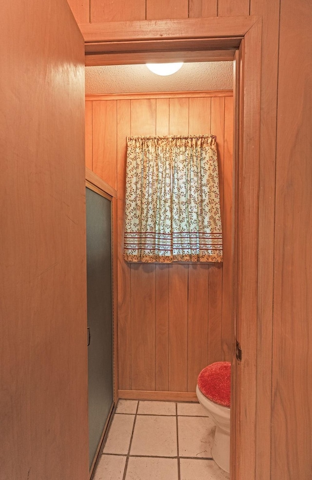 1345 10th St, Hempstead, TX 77445 - bathroom featuring wood walls, a shower stall, and toilet