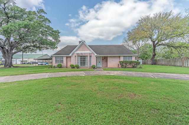 1345 10th St, Hempstead, TX 77445 - ranch-style house featuring brick siding, fence, curved driveway, and a front yard