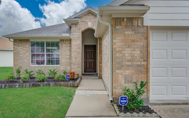 5823 Plantation Crest Dr, Katy, TX 77449 - property entrance with a shingled roof, brick siding, a yard, and a garage