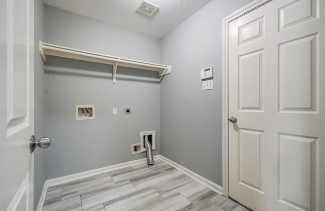 5823 Plantation Crest Dr, Katy, TX 77449 - laundry room featuring laundry area, visible vents, hookup for an electric dryer, washer hookup, and a textured ceiling