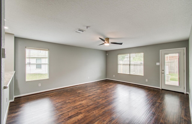 5823 Plantation Crest Dr, Katy, TX 77449 - empty room featuring a textured ceiling, ceiling fan, baseboards, dark wood-type flooring, and visible vents