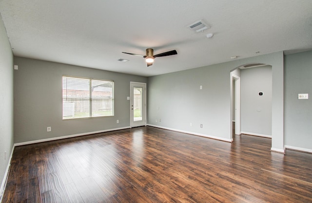 5823 Plantation Crest Dr, Katy, TX 77449 - spare room featuring arched walkways, a ceiling fan, dark wood-style flooring, and visible vents