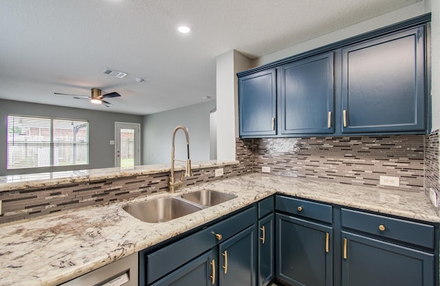 5823 Plantation Crest Dr, Katy, TX 77449 - kitchen featuring a sink, backsplash, and blue cabinetry