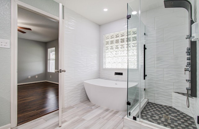 5823 Plantation Crest Dr, Katy, TX 77449 - full bathroom with recessed lighting, a ceiling fan, wood finished floors, a freestanding tub, and a shower stall