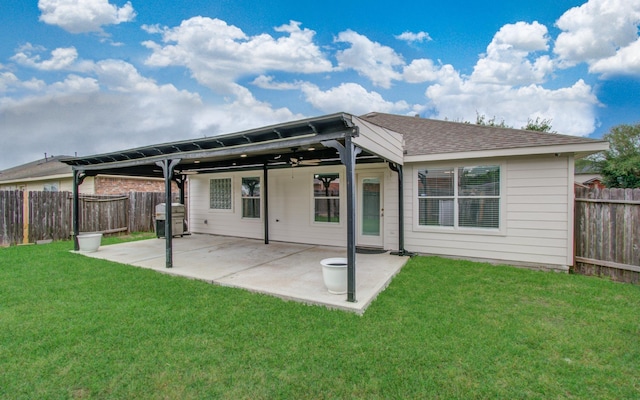5823 Plantation Crest Dr, Katy, TX 77449 - rear view of house featuring a shingled roof, a patio area, a fenced backyard, and a yard