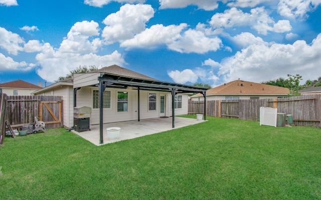 5823 Plantation Crest Dr, Katy, TX 77449 - back of house featuring a fenced backyard, a patio area, ceiling fan, and a lawn