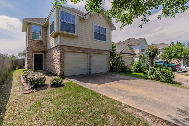 7850 Winding Creek Vw, Houston, TX 77072 - view of front facade featuring stone siding, concrete driveway, fence, an attached garage, and a front yard