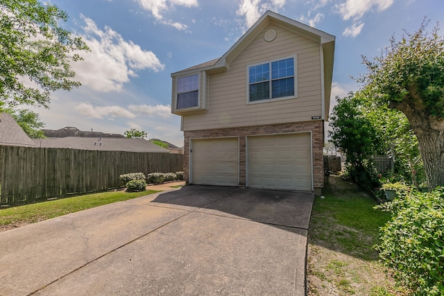 7850 Winding Creek Vw, Houston, TX 77072 - view of side of home with brick siding, an attached garage, driveway, and fence