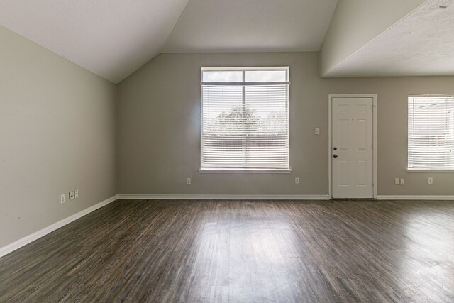 7850 Winding Creek Vw, Houston, TX 77072 - unfurnished living room featuring dark wood finished floors, lofted ceiling, and baseboards