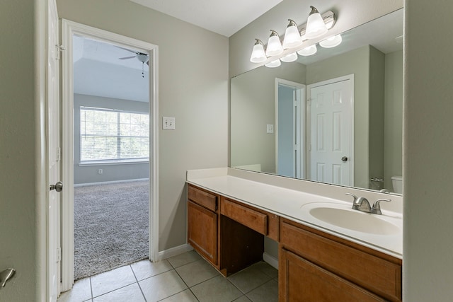 bathroom featuring baseboards, a ceiling fan, vanity, and tile patterned flooring