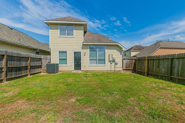 7850 Winding Creek Vw, Houston, TX 77072 - back of property with a fenced backyard, central AC, and a lawn