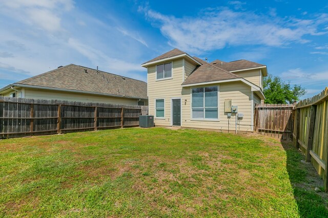 7850 Winding Creek Vw, Houston, TX 77072 - rear view of house featuring a lawn, a fenced backyard, and roof with shingles