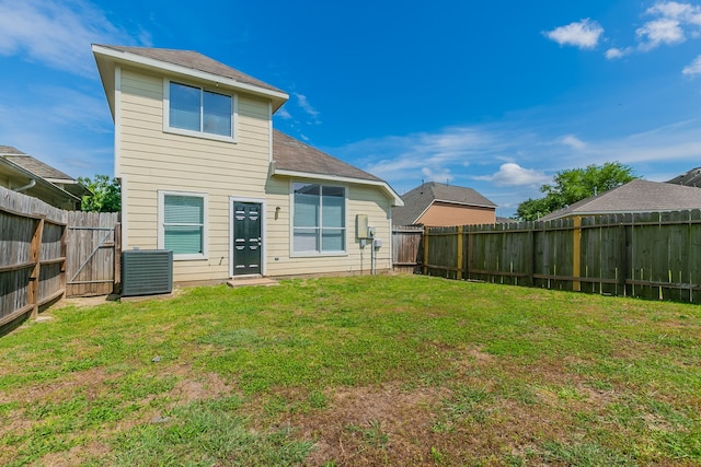 back of house with a lawn, a fenced backyard, and cooling unit