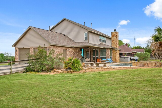 rear view of house with an attached garage, a lawn, roof with shingles, and a hot tub