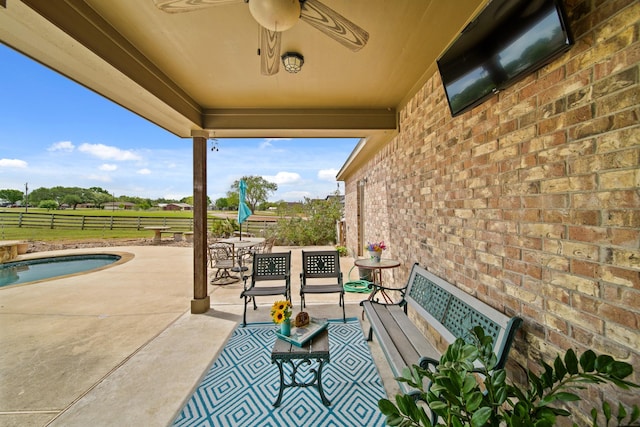 view of patio with fence and ceiling fan