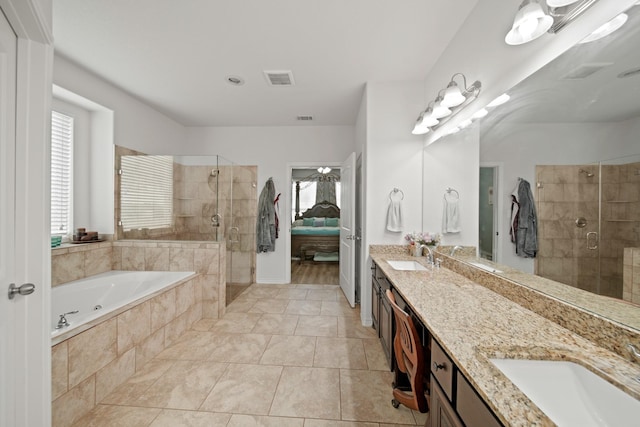 ensuite bathroom featuring a shower stall, a bath, a sink, and visible vents