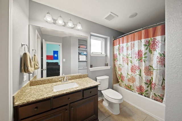 full bathroom featuring tile patterned floors, vanity, shower / tub combo with curtain, toilet, and visible vents
