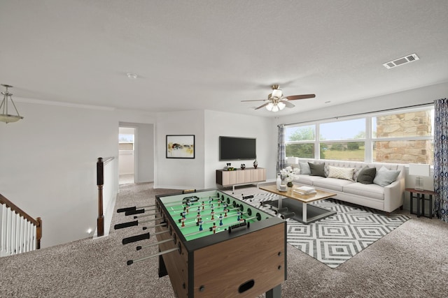 playroom featuring ceiling fan, carpet flooring, and visible vents