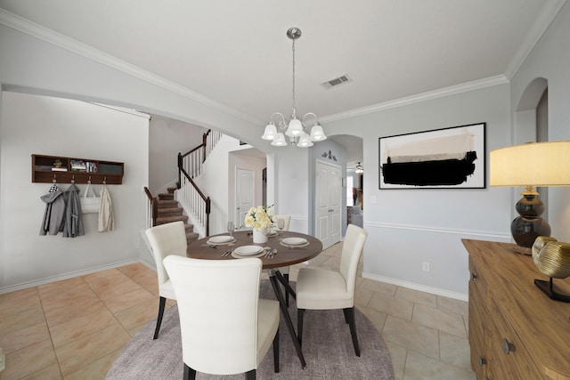 dining room with arched walkways, light tile patterned flooring, visible vents, stairs, and ornamental molding