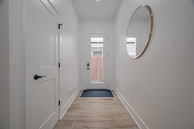 entryway featuring light wood finished floors and baseboards