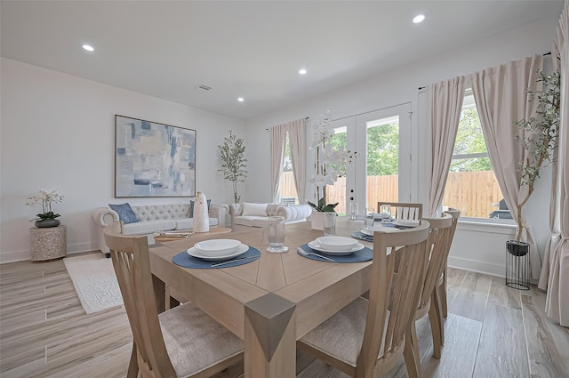 dining space featuring recessed lighting, light wood-type flooring, baseboards, and french doors
