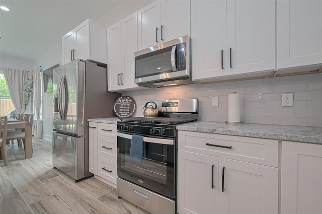 kitchen featuring white cabinetry, appliances with stainless steel finishes, and tasteful backsplash