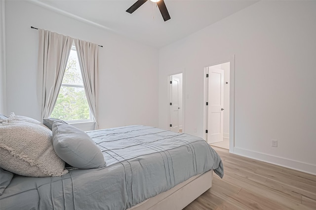 bedroom featuring light wood-type flooring, baseboards, and ceiling fan