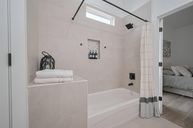 ensuite bathroom with shower / tub combo and ensuite bath