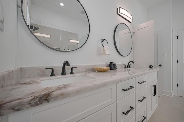 full bath featuring tile patterned flooring, a sink, and double vanity