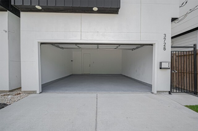 garage featuring concrete driveway